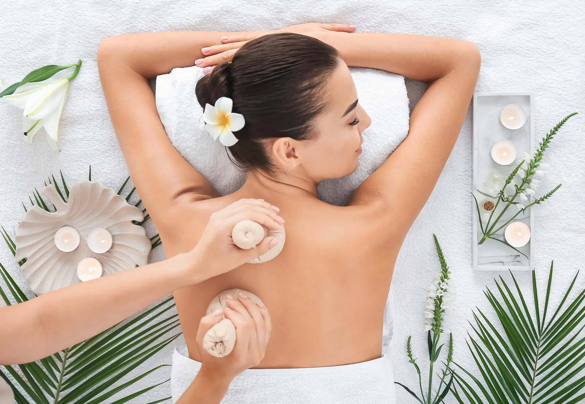 Back massage with herbal pouches for relaxation at Stanford Massage Wellness Beauty, a Beauty And Wellness Store in Menlo Park